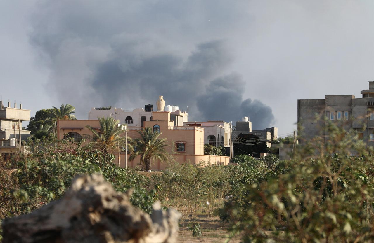 Smoke rises during heavy clashes between rival factions in Tripoli, Libya.