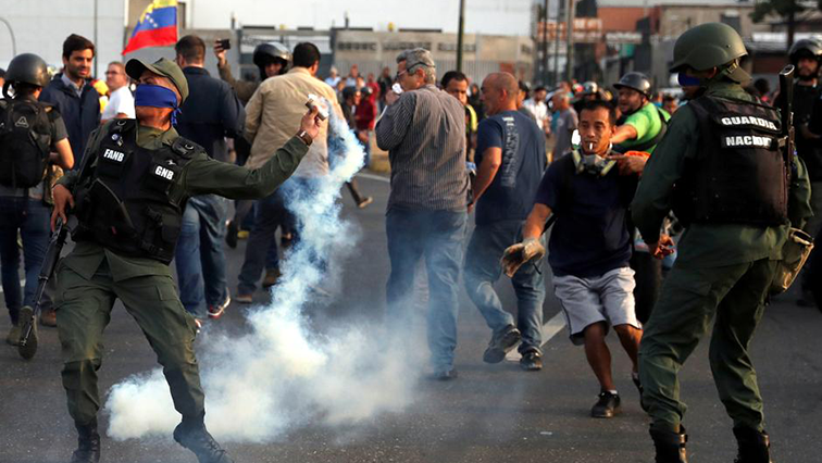 A military member throws a tear gas canister near the Generalisimo Francisco de Miranda Airbase "La Carlota", in Caracas, Venezuela April 30, 2019.