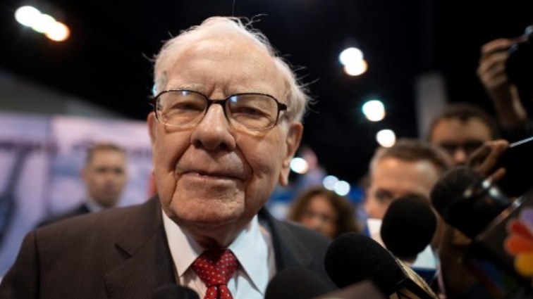 Warren Buffett (C), CEO of Berkshire Hathaway, speaks to the press as he arrives at the 2019 annual shareholders meeting in Omaha.