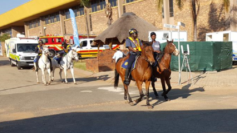 Police officials riding horses