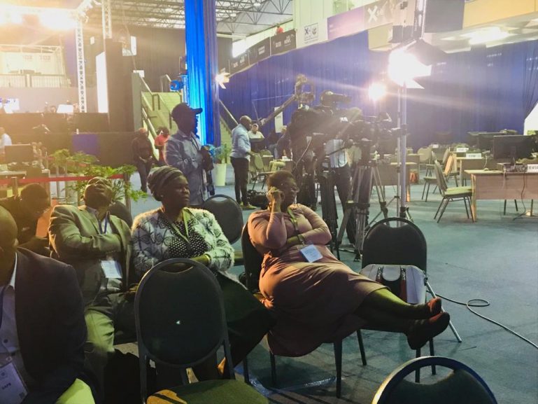 People sitting during a briefing of the IEC