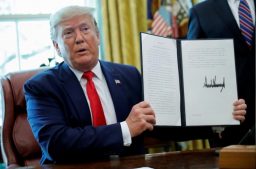 US President Donald Trump displays an executive order imposing fresh sanctions on Iran in the Oval Office of the White House in Washington, US