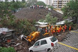 Rescue workers look for survivors among the debris of a collapsed wall of a residential complex in Pune, India.