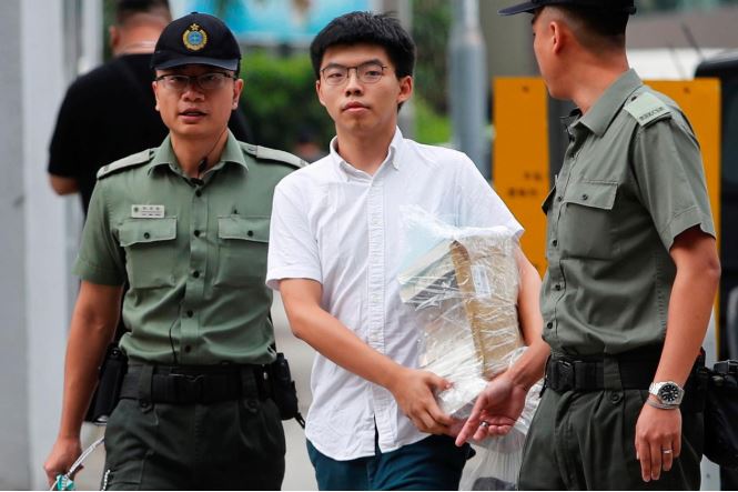 Former student leader Joshua Wong walks out from prison after being jailed for his role in the Occupy Central movement, also known as “Umbrella Movement”, in Hong Kong.