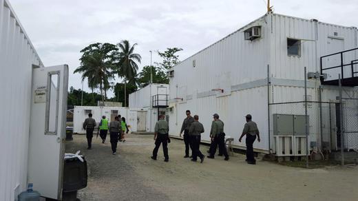 Authorities inside the Manus Island refugee camp in Papua New Guinea walk around the camp serving deportation notices to detainees.