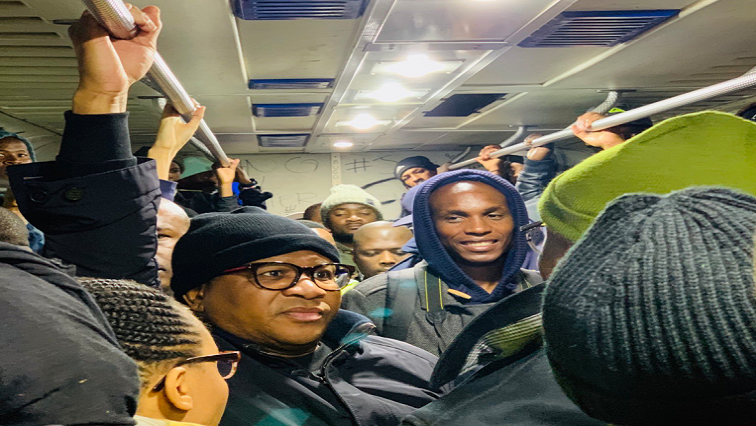 Fikile Mbalula standing in a train