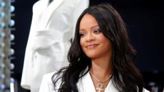 Pop superstar Rihanna poses in a pop-up store to present her first collection with LVMH for the new label, Fenty.