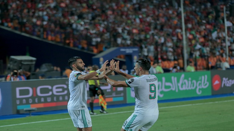 Two Algerian players celebrating