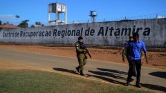 A police officer patrols the surroundings of the Altamira Regional Recovery Centre after t least 52 inmates were killed in a prison riot, in the Brazilian northern city of Altamira.