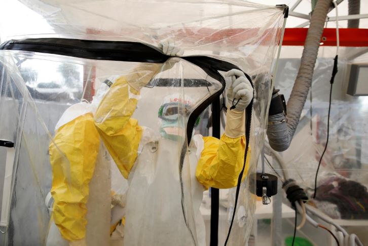 A health worker wearing Ebola protection gear enters the Biosecure Emergency Care Unit (CUBE) at the ALIMA (The Alliance for International Medical Action) Ebola treatment centre in Beni, in the Democratic Republic of Congo.