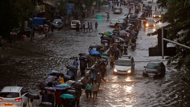 At least 14 dead as Mumbai hit by flooding Severe disruption caused after India’s financial capital hit by month’s rainfall in a day Wed, Aug 30, 2017, 10:41 Updated: Wed, Aug 30, 2017, 18:52 Commuters walk through water-logged roads after rains in Mumbai on Tuesday. Photograph: Shailesh Andrade/Reuters Commuters walk through water-logged roads after rains in Mumbai on Tuesday.