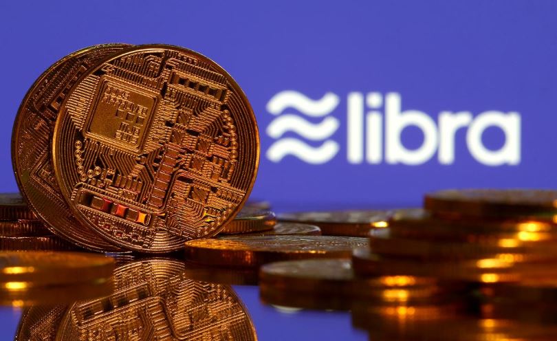 Representations of virtual currency are displayed in front of the Libra logo in this illustration picture.