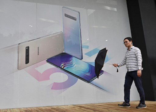 A man walks past an advertisement for the Samsung Galaxy S10 5G smartphone in Seoul on July 31, 2019.