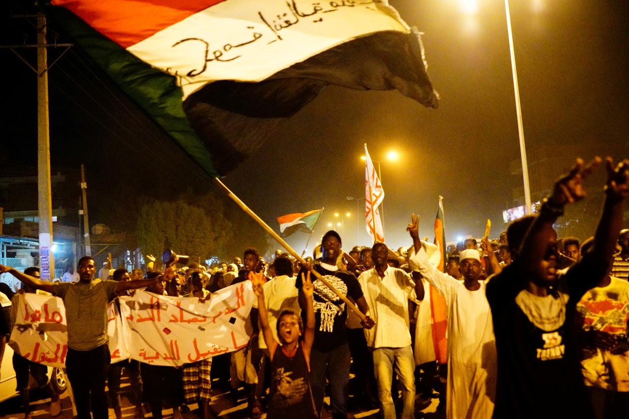 Sudanese people, seeking to revive a push for civilian rule in ongoing tumult since the overthrow of former President Omar al-Bashir more than two months ago, chant slogans and wave Sudanese flags during a demonstration in Khartoum