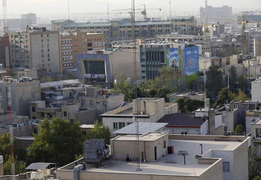 A man smokes on a rooftop in Tehran, Iran.