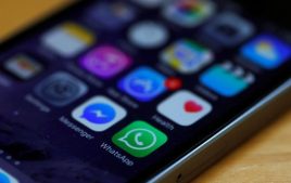 WhatsApp and Facebook messenger icons are seen on an iPhone in Manchester.