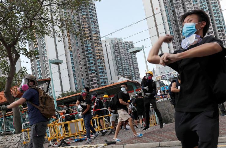 Protesters hurl objects at the police during a demonstration in support of the city-wide strike and to call for democratic reforms at Tin Shui Wai in Hong Kong.
