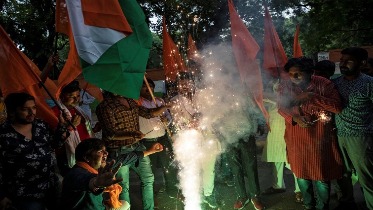 People burn firecrackers as they celebrate after the government scrapped the special status for Kashmir