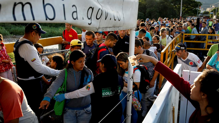 Colombian migration officers check the identity documents of people trying to enter Colombia from Venezuela, at the Simon Bolivar International bridge in Villa del Rosario, Colombia.