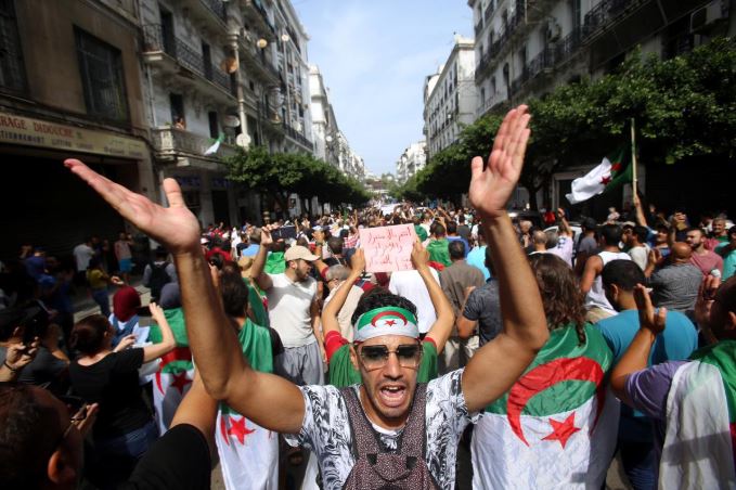 Demonstrators shout slogans during a protest to reject the Algerian election announcement for December, in Algiers, Algeria.