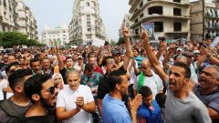 Demonstrators gesture and shout slogans during a protest rejecting Algerian election announcement for December, in Algiers, Algeria.