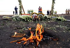 Candle flames burn during a commemoration ceremony for the victims at the scene of the Ethiopian Airlines Flight ET 302 plane crash, near the town Bishoftu, near Addis Ababa.