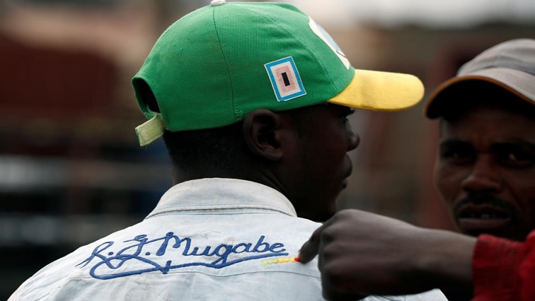 A man wearing Zimbabwe's former president Robert Mugabe regalia, is seen in Glen View, Harare.