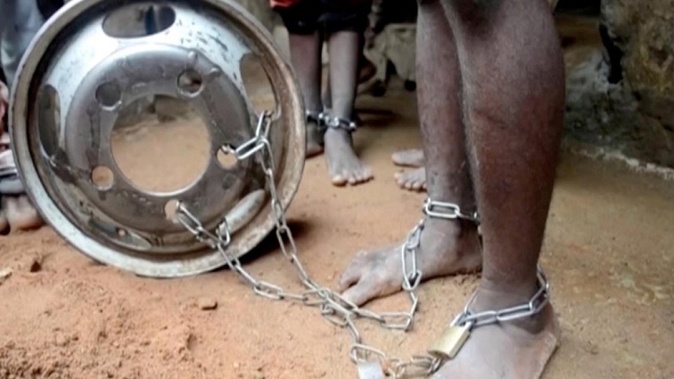 People with chained legs are pictured after being rescued from a building in the northern city of Kaduna, Nigeria.