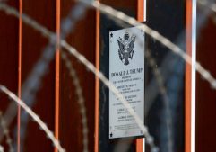 A plaque commemorating U.S. President Donald Trump hangs on the U.S.-Mexico border fence as Trump visits the U.S.-Mexico border in Calexico, California.