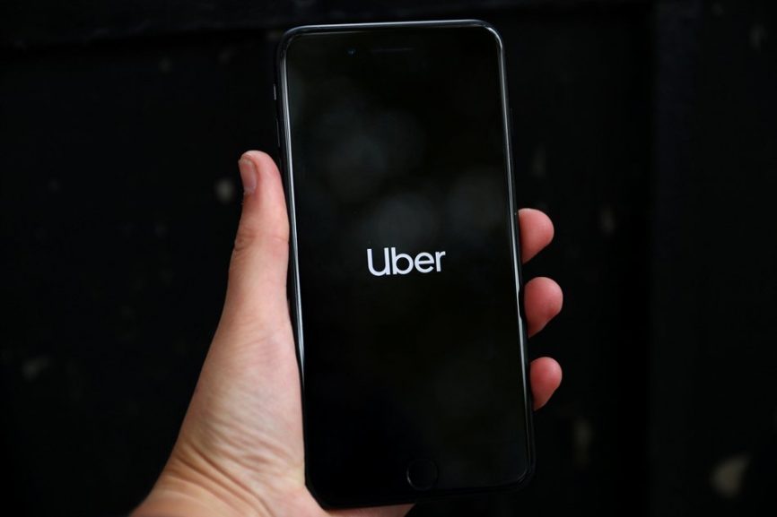 Uber's logo is displayed on a mobile phone in London.