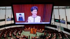 Hong Kong Chief Executive Carrie Lam is seen on a screen as she reacts to protests by pro-democracy lawmakers, at the Legislative Council in Hong Kong.