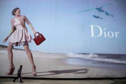 A man walks past a Dior advertisement outside a shopping mall in Wuhan, Hubei province.