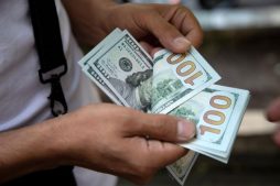 A man counts U.S. dollars in Tehran.