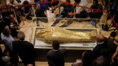 The Gold Coffin of Nedjemankh surrounded by members of media during a news conference to announce its return from the US and display at the National Museum of Egyptian Civilization.