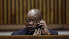 Former South African President Jacob Zuma speaks on the phone during the court appearance.