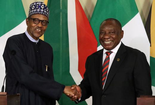 Nigeria's President Muhammadu Buhari shakes hands with his South African counterpart Cyril Ramaphosa during a news conference.