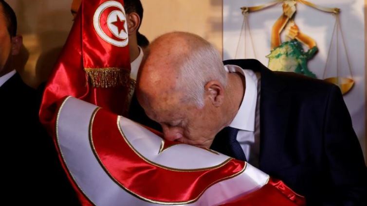 Tunisian presidential candidate Kais Saied reacts after exit poll results were announced in a second round runoff.