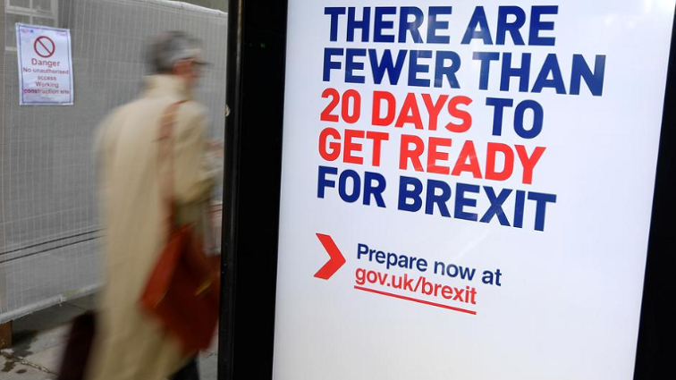 A man walks past a UK government Brexit information campaign poster at a bus stop in central London, Britain, October 15, 2019.