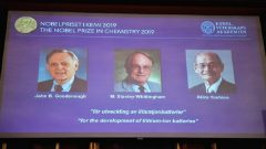 A screen displays the portraits of the laureates of the 2019 Nobel Prize in Chemistry.