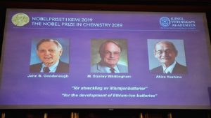 A screen displays the portraits of the laureates of the 2019 Nobel Prize in Chemistry.