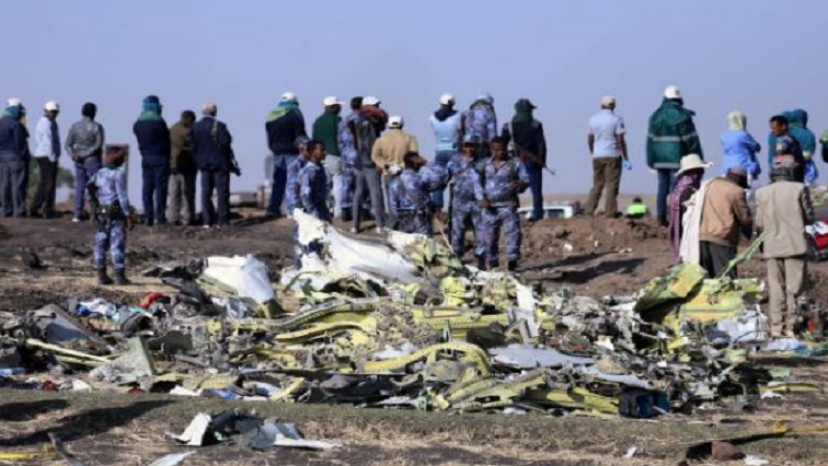 Ethiopian Federal policemen stand at the scene of the Ethiopian Airlines Flight ET 302 plane crash, near the town of Bishoftu.
