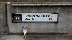 Flowers are laid down for the victims at the scene of a stabbing on London Bridge, in which two people were killed, in London, Britain, November 30, 2019.