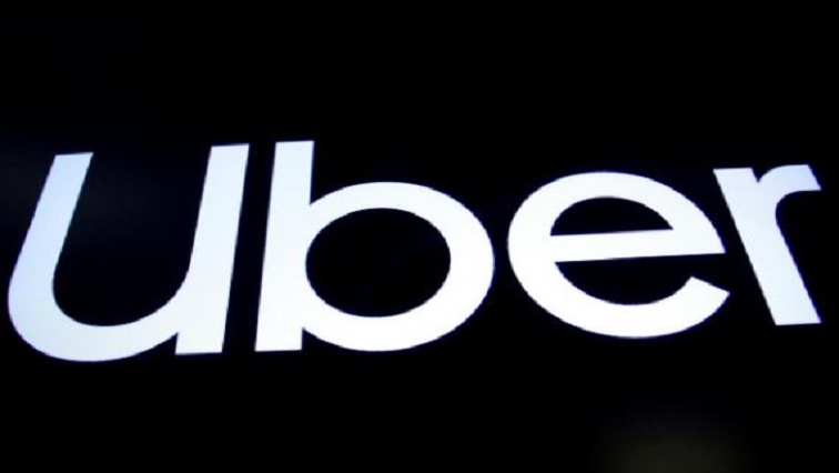 A screen displays the company logo for Uber Technologies Inc. on the day of it's IPO at the New York Stock Exchange.