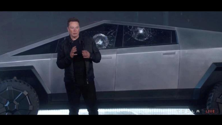 Tesla Chief Executive Elon Musk stands in front of the cracked windows of company's first electric pickup truck, the Cybertruck, after it was unveiled and a metal ball was thrown at the windows, in Los Angeles, California U.S., November 21, 2019.