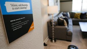 Prompts on how to use Amazon's Alexa personal assistant are seen as a wifi-equipped Roomba begins cleaning a room in an Amazon ‘experience center’ in Vallejo, California.