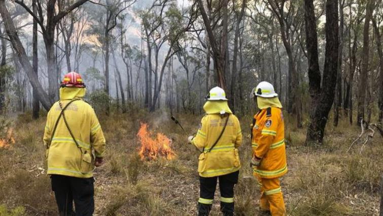 Australian firefighters used cooler conditions on Christmas Day to try and contain bushfires ahead of hot, dry weather.