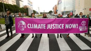 Activists hold a banner during a protest against climate change as the COP25 climate summit is held in Madrid.