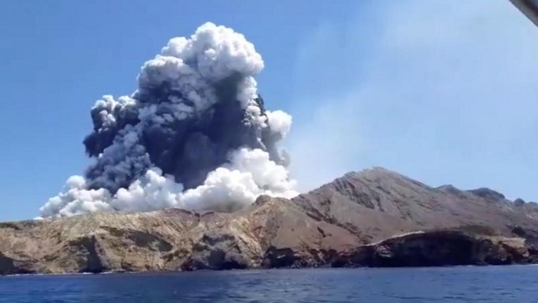 Smoke from the volcanic eruption of Whakaari, also known as White Island, is pictured from a boat.
