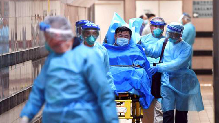 Medical staff transfer a patient of a highly suspected case of a new coronavirus at the Queen Elizabeth Hospital in Hong Kong, China.