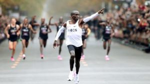 Kenya's Eliud Kipchoge, the marathon world record holder, crosses the finish line during his attempt to run a marathon in under two hours in Vienna, Austria.